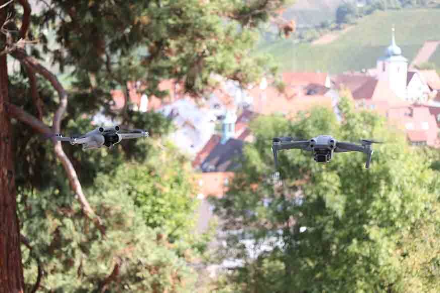 Die DJI Air 2S und DJI Mini 3 Pro fliegen nebeneinander.